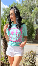 picture 1 woman in Smiley Comfort Tee | Turquoise with white shorts 