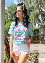 picture 2 woman in Smiley Comfort Tee | Turquoise with white shorts 