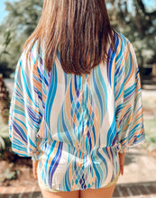 back of Alright Tonight Lantern Top is just the same abstract print and color as front long in back picture 4 woman wearing it