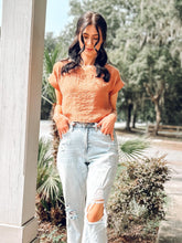 picture 1 girl wearing Risa Boxy Crop Top | Rust with jeans