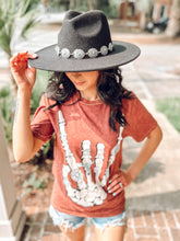 picture 2 girl wearingWestern Skeleton Hand Tee | Wine with hat on head with shorts