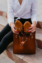 picture 3 woman packing Honey Buckle Mules Rollasole